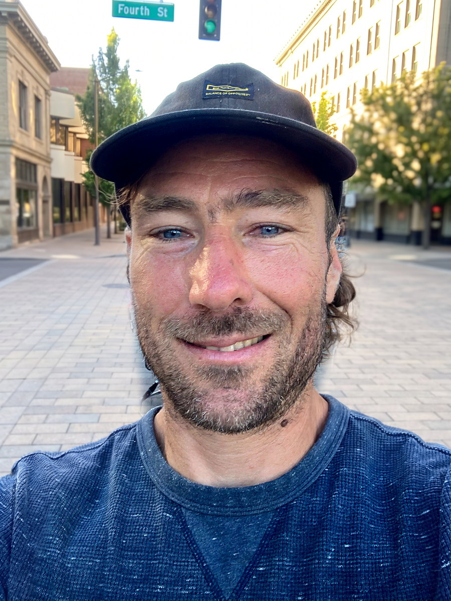 Mark Grumich, owner of ProRosa, in a cap and work shirt on Fourth Street in downtown Santa Rosa.